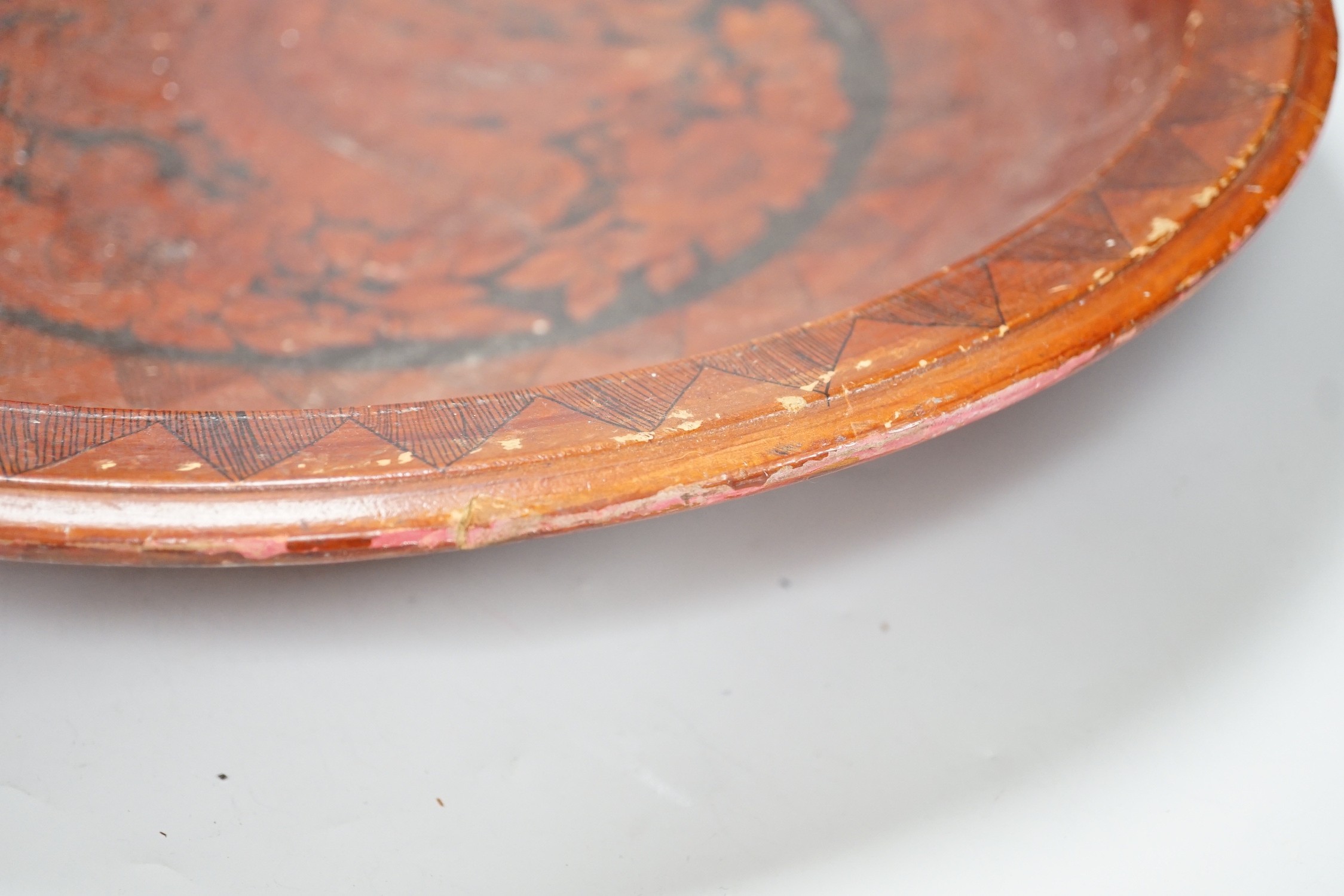 A pair of early 20th century Chinese carved red lacquer and gilt temple incense burners and a similar Asian lacquer dish, dish 44.5cms diameter